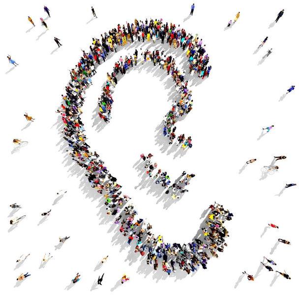 People standing in a shape of an ear 2